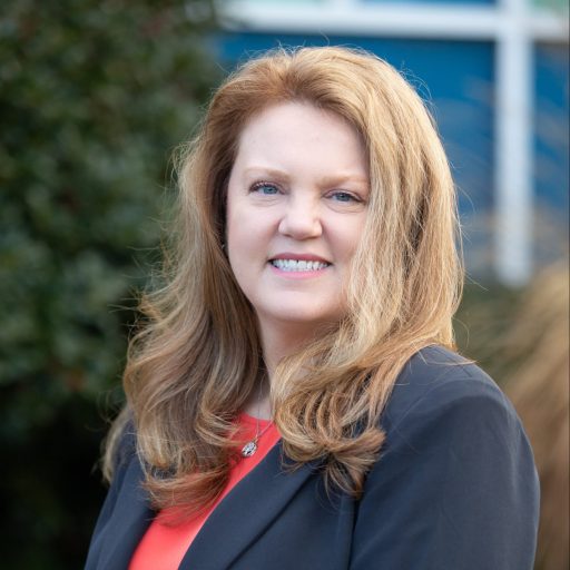 business woman with auburn hair and navy jacket